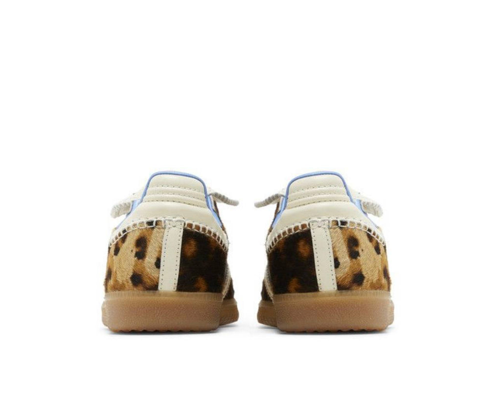 Pair of shoes with leopard print soles on a white background