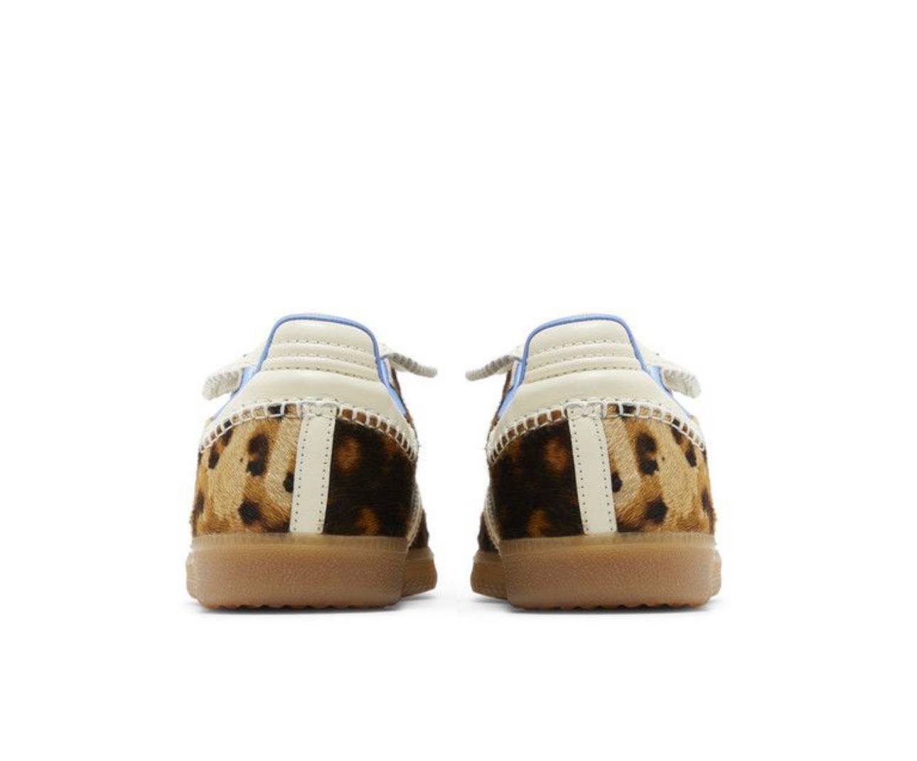Pair of shoes with leopard print soles on a white background